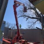 Bucket truck in the sky cutting a tree