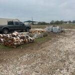 A pile of fire for sale near work trucks