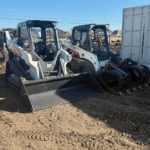 2 backhoes parked in a dirt lot getting ready for some land clearing